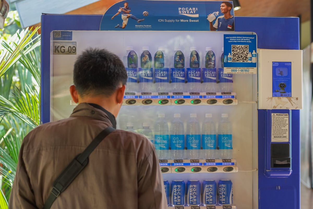 Jakarta , Indonesia - April 14, 2026 : A man buying drinks at the Vending machine